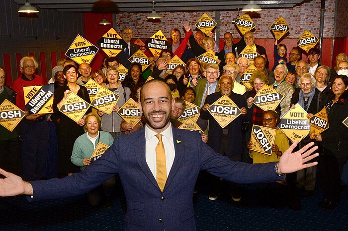 Supporters with placards at a Liberal Democrat election campaign event